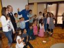 Surrounded by happy students, astronaut Lee Morin, KF5DDB and Joe K6WAO lead the team in giving a "thumbs up" for a successful contact with the International Space Station.